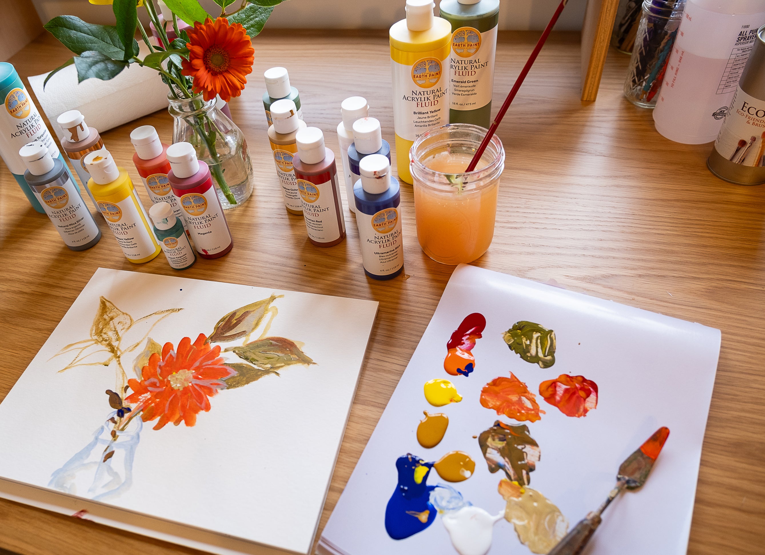 fluid acrylic paint set up with pallet and flower painting