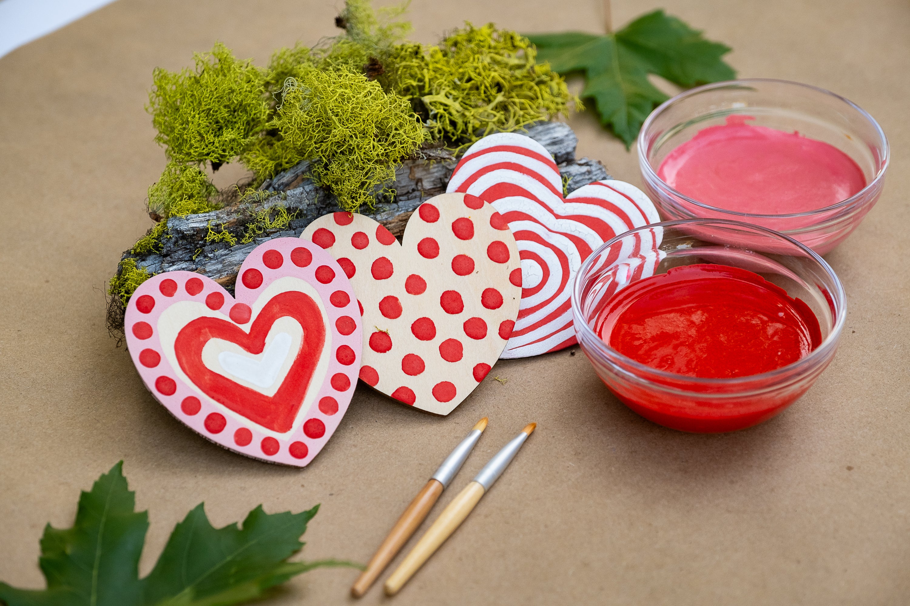 painted wooden hearts and bowls of paint