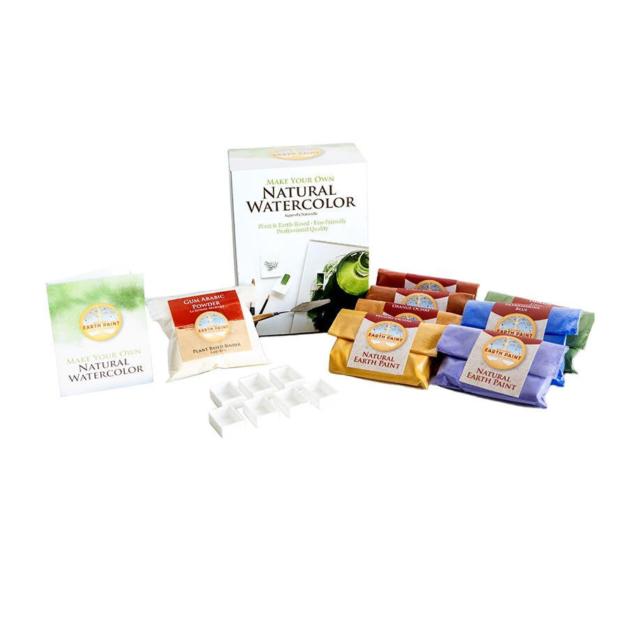 Components of the Natural Watercolor Kit including the box, seven packets of pigment, a packet of Gum Arabic powder, seven watercolor paint pans and an instruction booklet