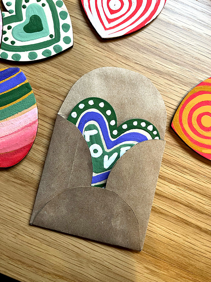 wooden painted hearts inside handmade envelope