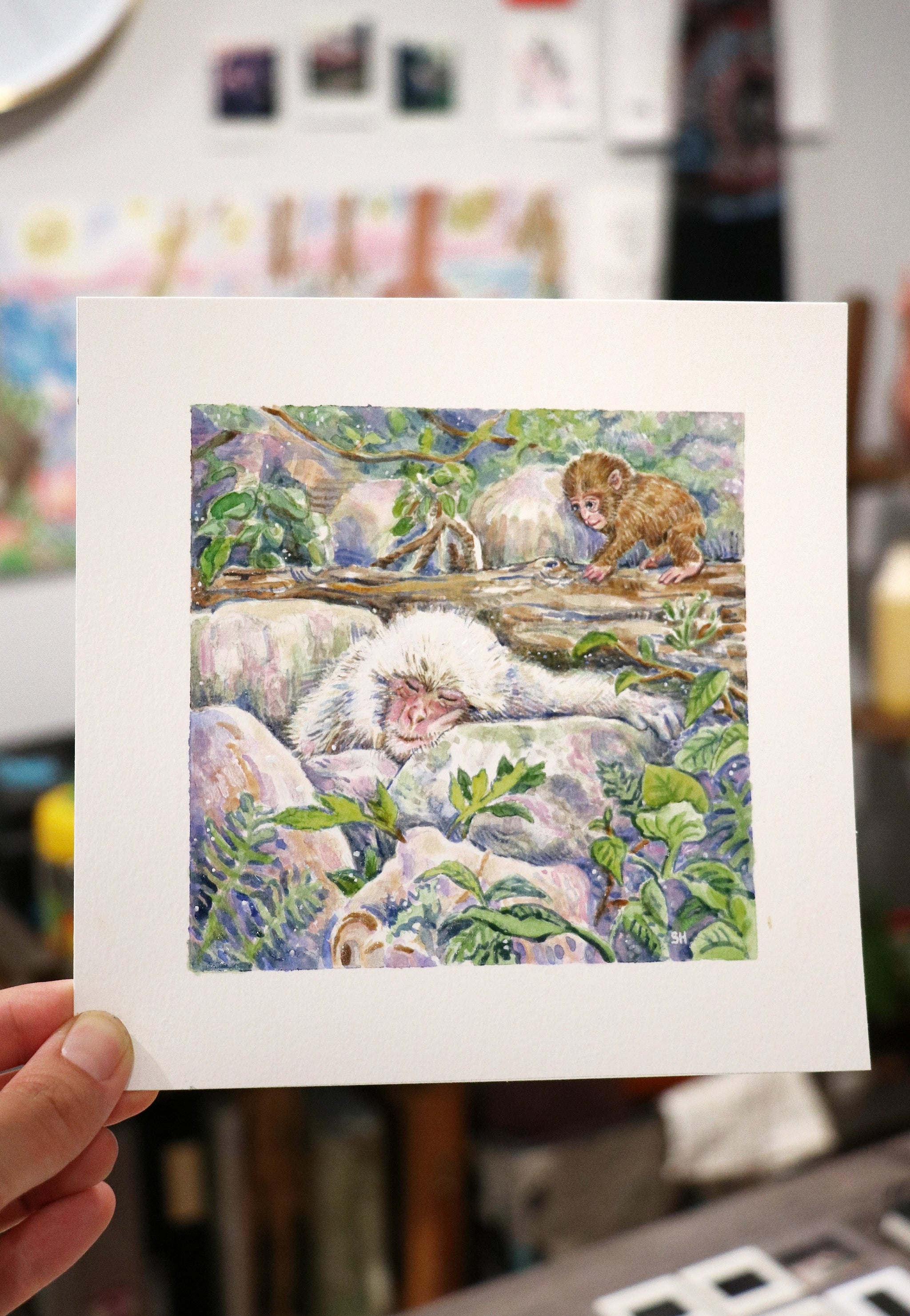 Painting by Shirley Huang of two monkeys in the wild - One larger, sleeping white one and a younger, smaller brown one ontop of a fallen log