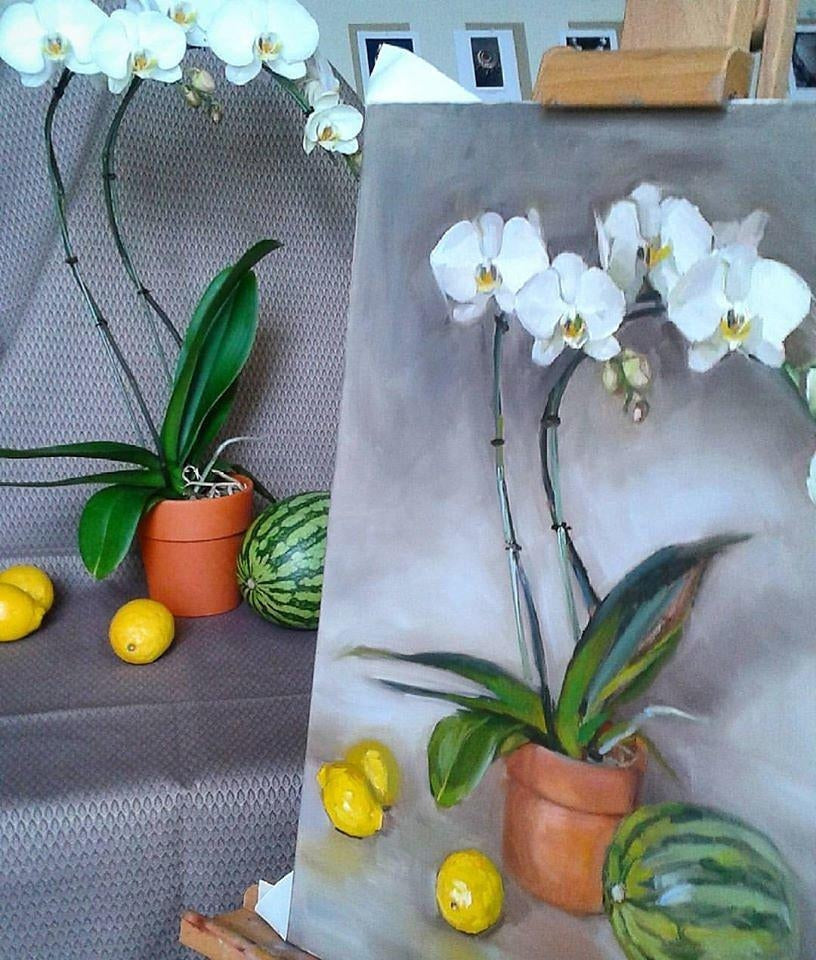 Canvas painting of a still life with white orchids in a clay pot on a grey background with 3 lemons and a watermelon