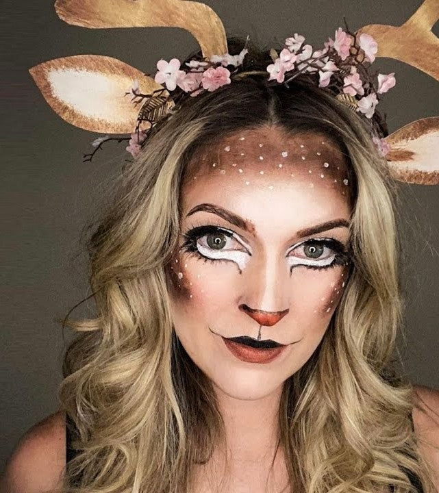 Photo of a woman's face painted as winter reindeer by face paint artist Kate Dascoli