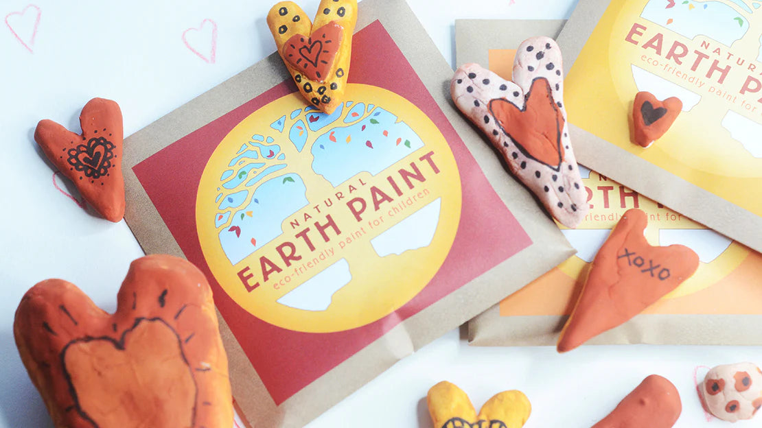 Natural Earth Paint packet surrounded by painted air dry clay hearts 