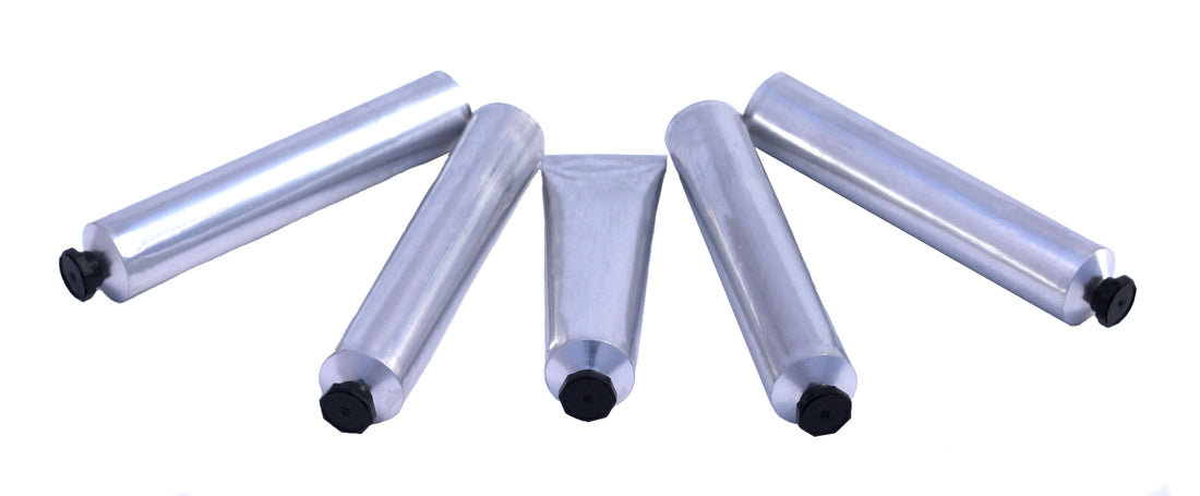 Close-up image of five empty aluminum paint tubes on a white background