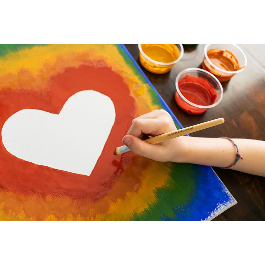 Little hand painting rainbow heart using Bamboo Paint Brush