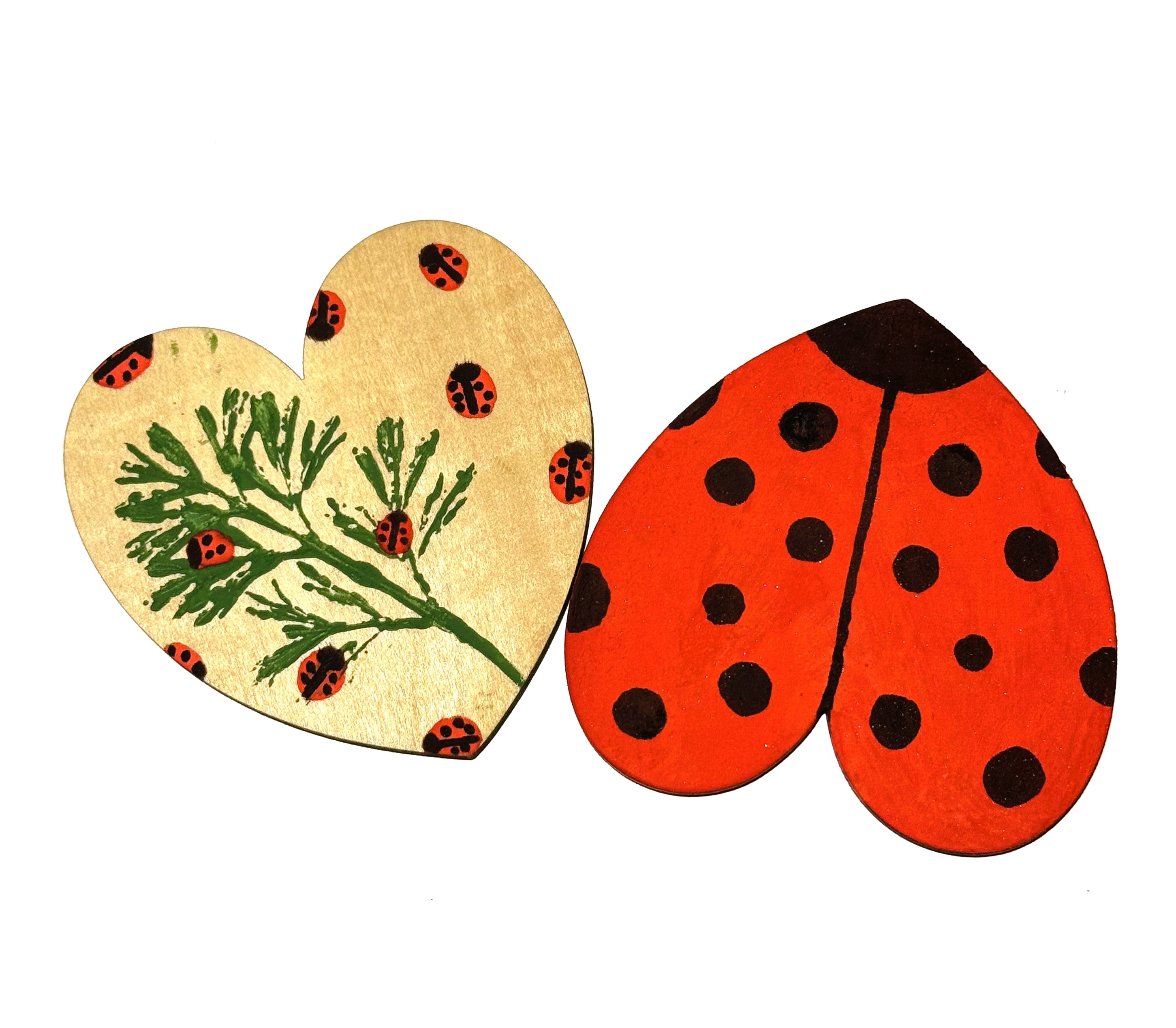 Image of 2 painted hearts, one as a ladybug, and one with a stamp of a leaf with little ladybugs painted all over it