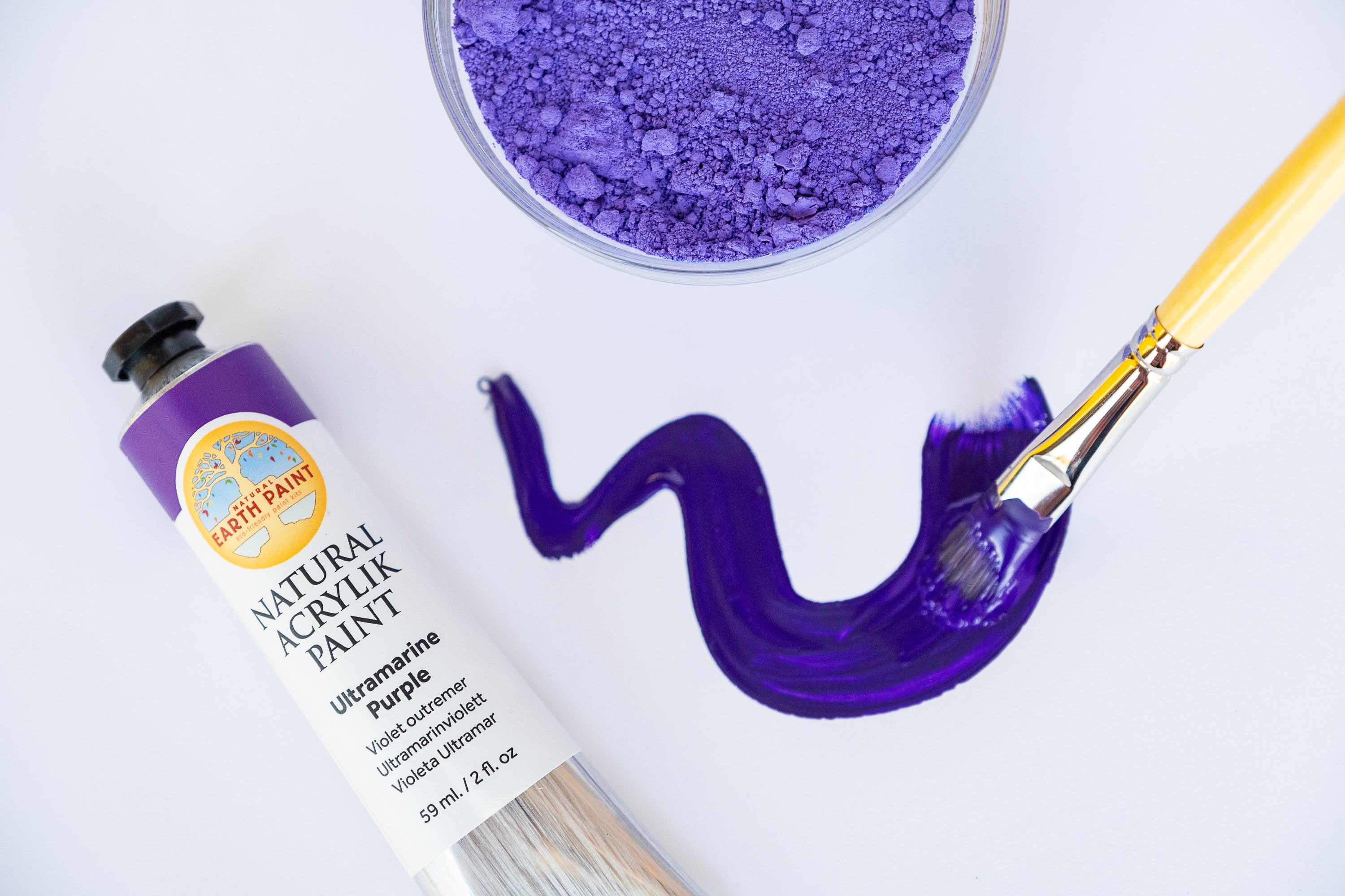 purple natural acrylic paint pigment and brush