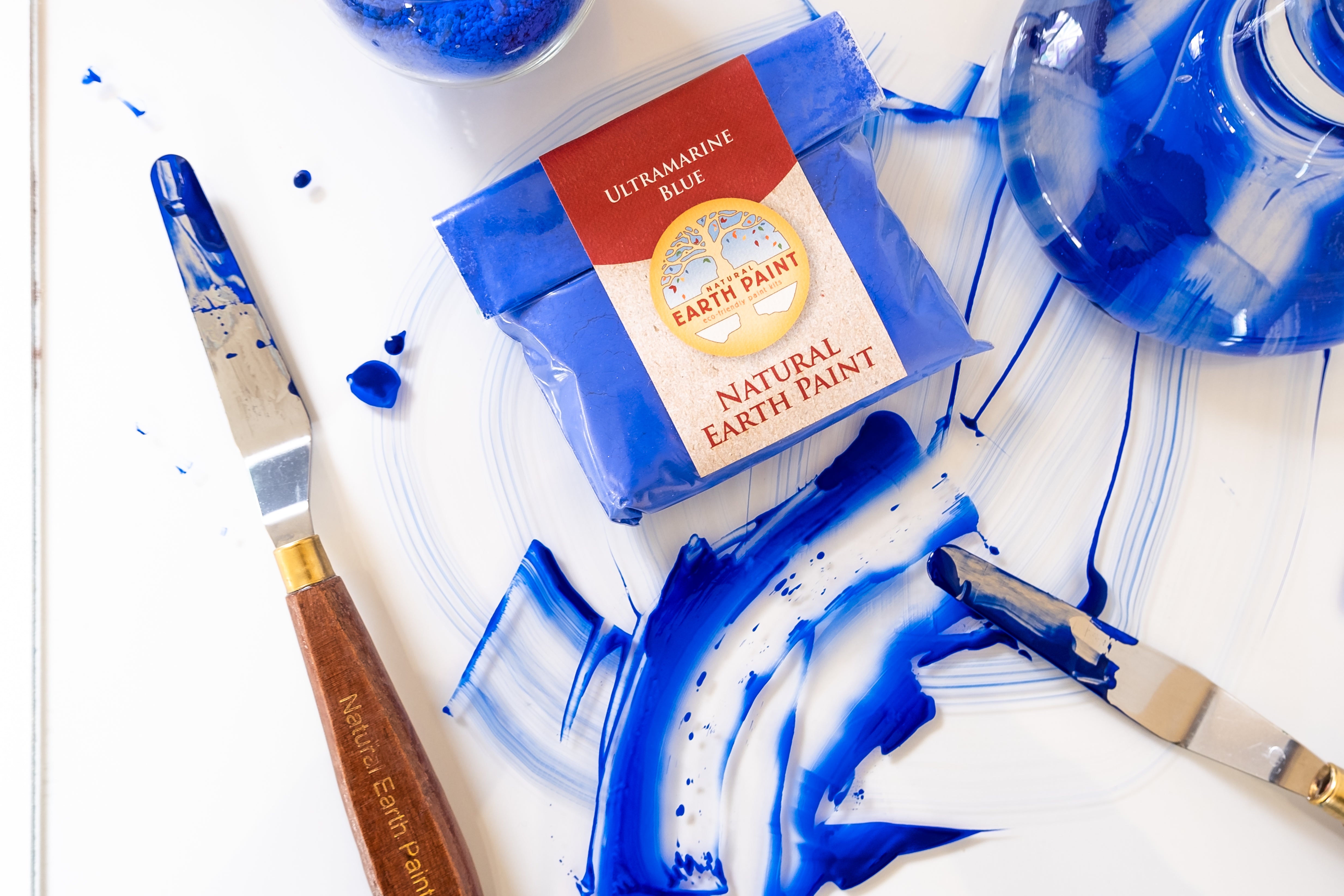 Ultramarine blue paint smeared around a glass palette