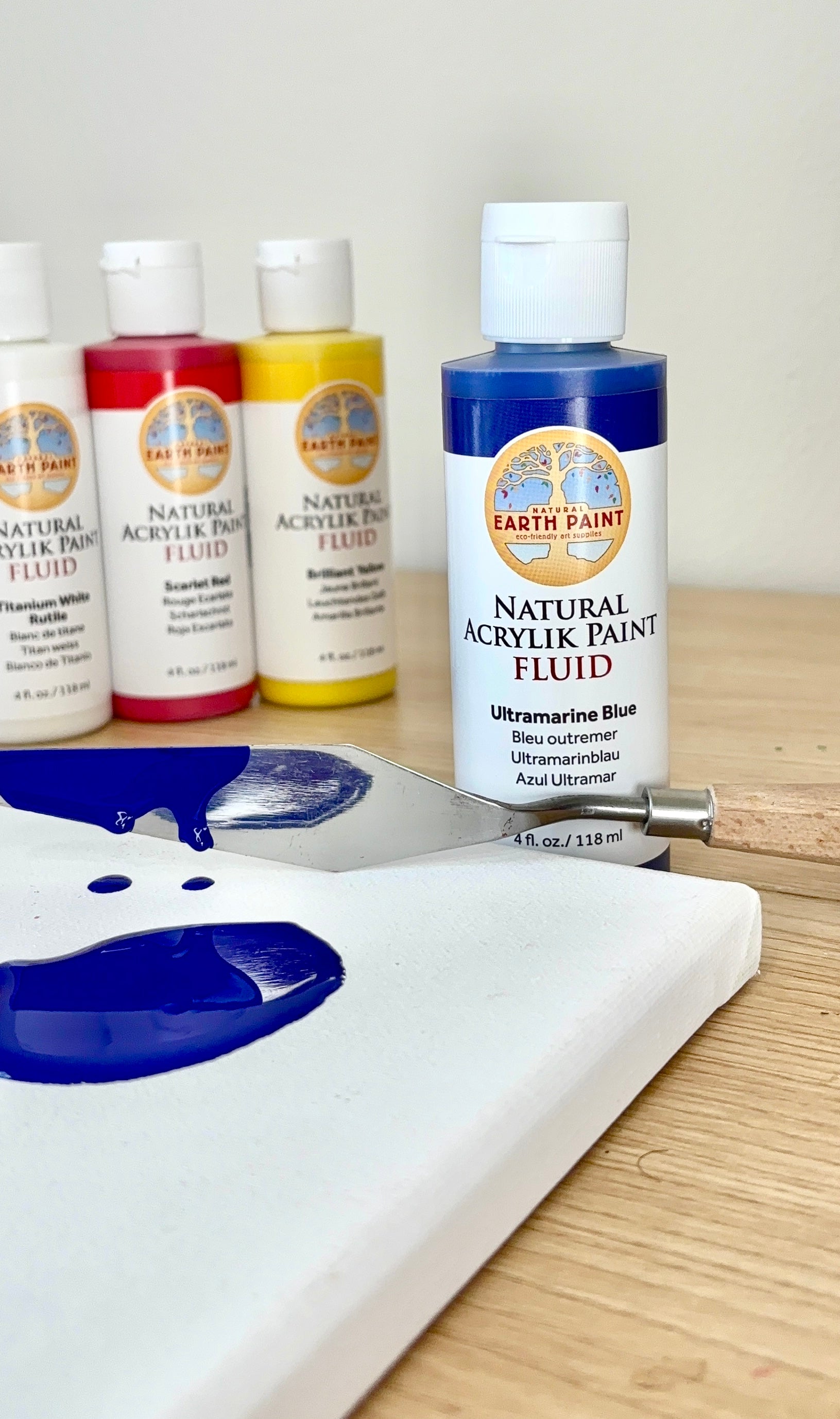 blue fluid acrylic paint on canvas with pallet knife