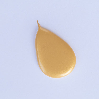 A teardrop-shaped blob of Gold Mica acrylic paint