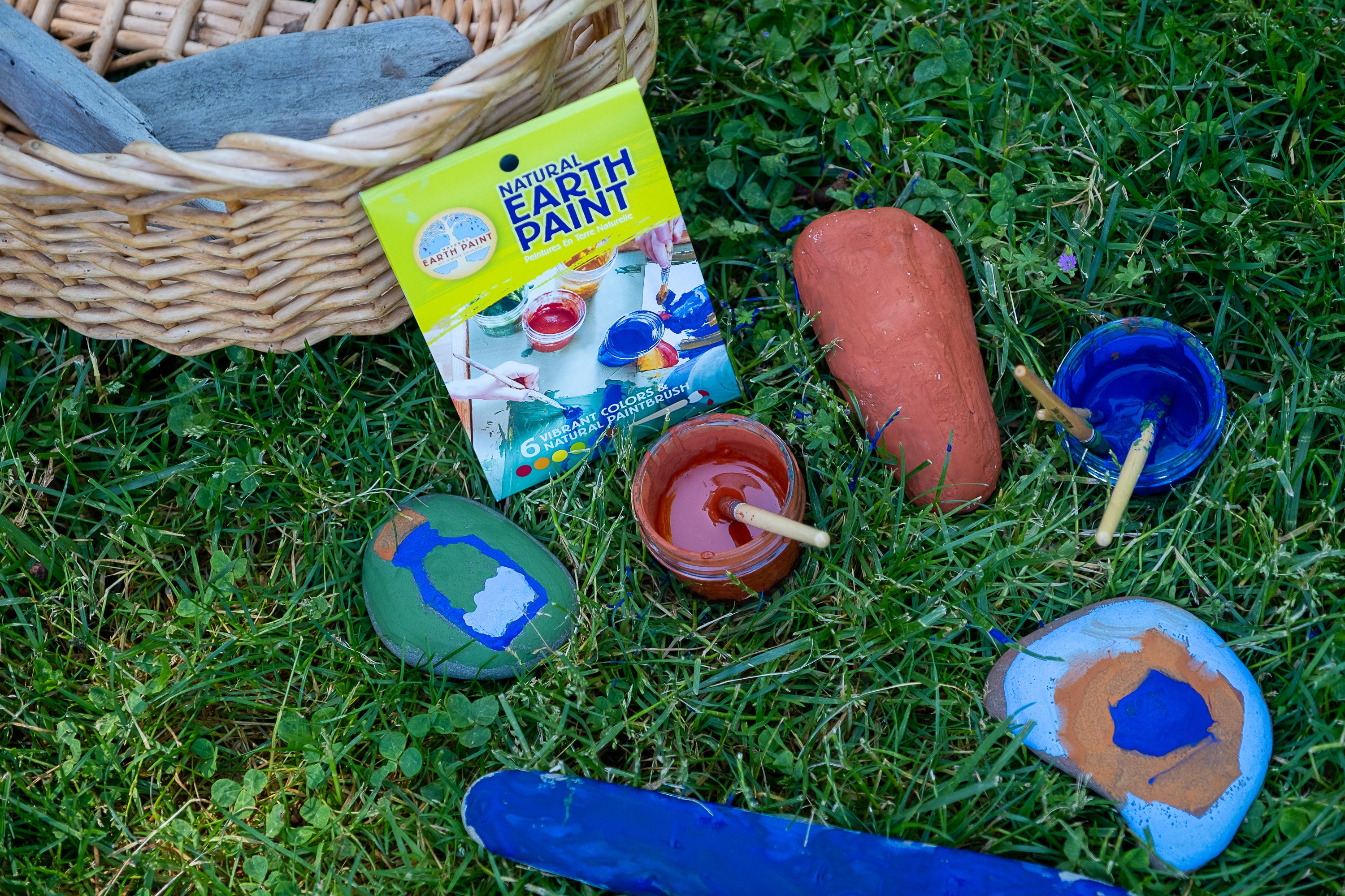 children painted stones in grass